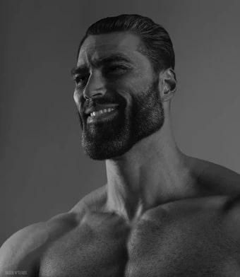 A black and white portrait shows a muscular smiling man.